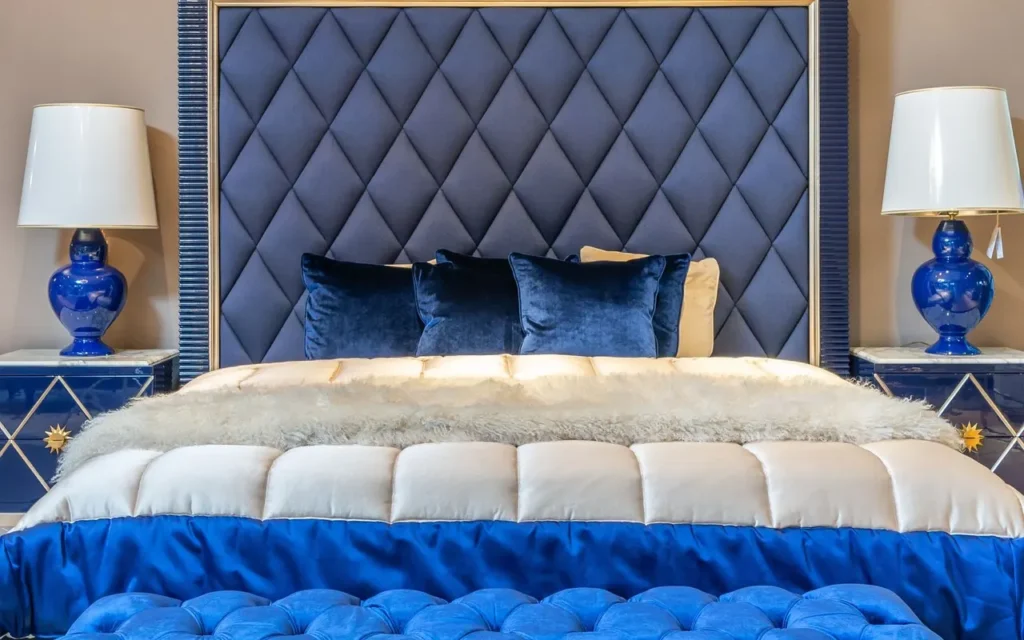 Bed with a blue tufted upholstered headboard