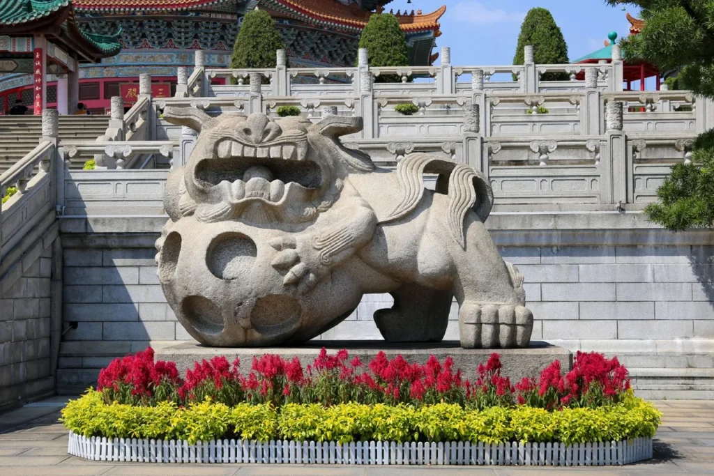 Stone guardian lion in a Chinese temple garden