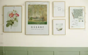 Framed botanical prints hung above green wall panelling