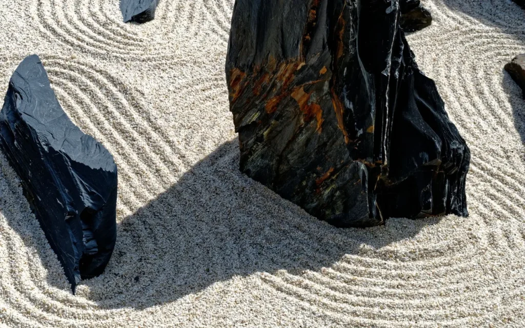 Raked sand and dark rocks in a quiet zen garden