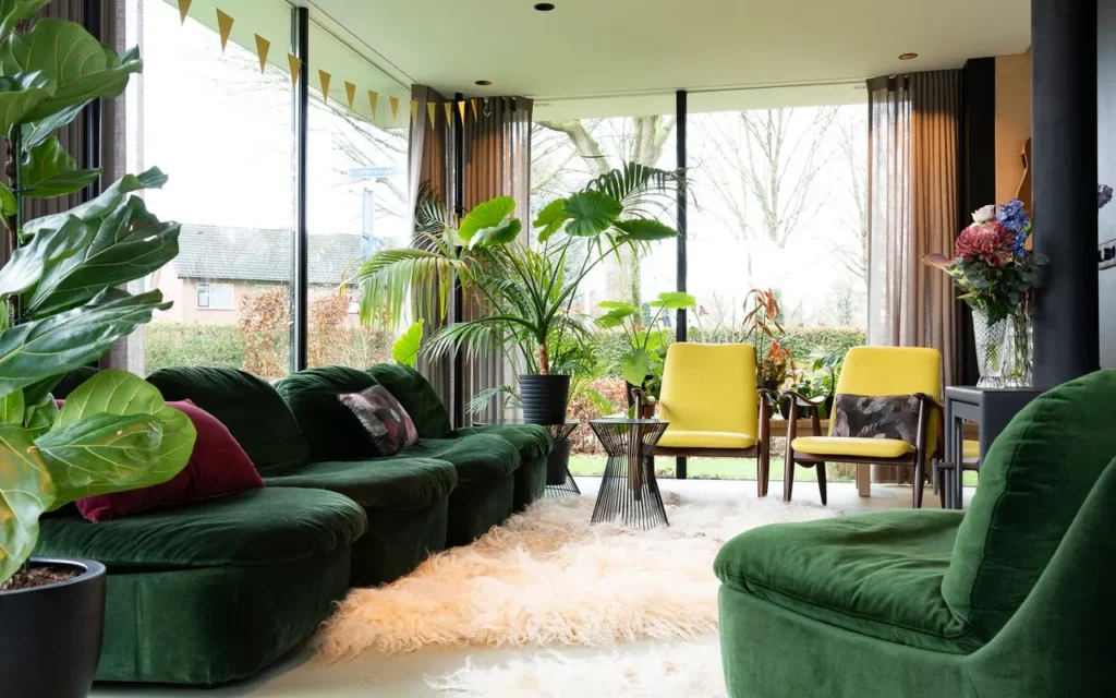 Living room with green sofas and large houseplants