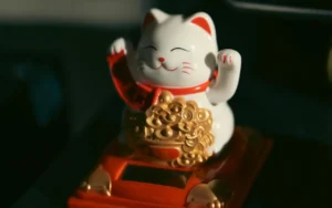 Maneki-neko lucky cat figurine on a desk