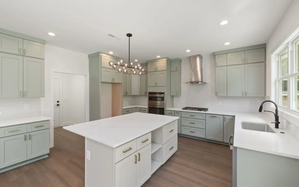 Kitchen with mint-green cabinets and a white island