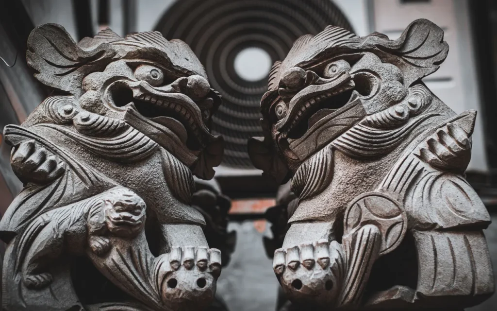 A pair of carved stone guardian lions, often called foo dogs