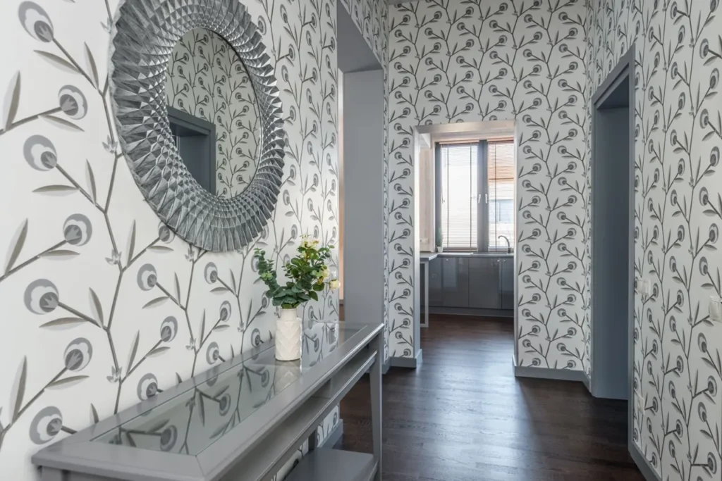 Round decorative mirror on a patterned hallway wall
