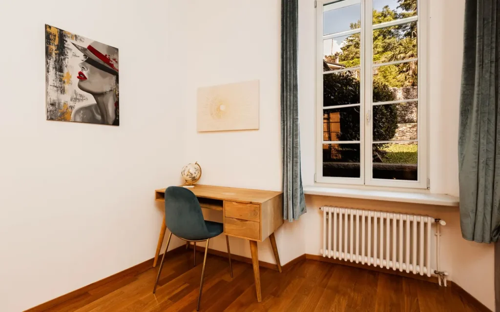Feng Shui Career Area: Aligning With Professional Success Simple desk and chair beside a tall window