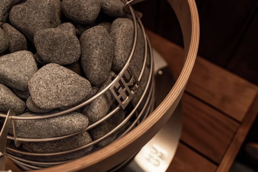 Smooth stones in a metal frame on a wooden surface